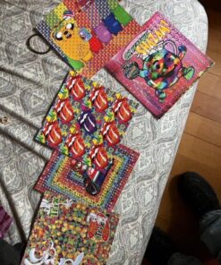 Full sheet of acid blotter paper featuring vivid printed designs across perforated LSD tab squares