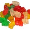 Assorted colorful fruit-flavored LSD gummy bears in red, orange, yellow, and green on a white background