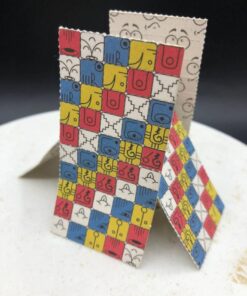 Close-up of colorful LSD blotter paper tabs with printed artwork on perforated squares