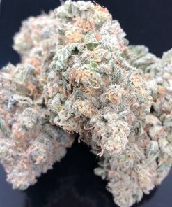 White Widow hybrid cannabis buds with chunky conical shape, spring green leaves, and dense frosty trichome coating