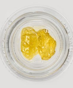 Premium live resin extract portion on dab tool displaying glossy texture ready for dabbing