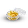Golden crumble cannabis concentrate with dry, crumbly texture on a flat surface