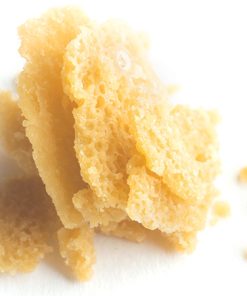 Close-up of premium THC crumble concentrate showing its characteristic dry, breakable texture