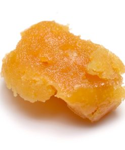 Premium cannabis budder concentrate with a waxy frosting-like texture in a small container, available in multiple strains