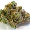 Blue Dream sativa-dominant hybrid cannabis flower buds with frosty trichomes, vibrant green coloring, and orange pistils