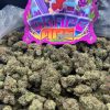 Grape Ape strain dense purple and green indica buds with copper pistils and heavy trichome coverage
