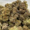 Granddaddy Purple indica strain close-up showing deep purple buds with white crystal resin trichomes