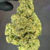 Green Crack cannabis buds - potent sativa strain with vibrant green leaves, high THC content, and citrusy aroma.