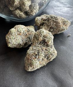 Purple Haze weed strain close-up showing lavender and green buds with trichome coating