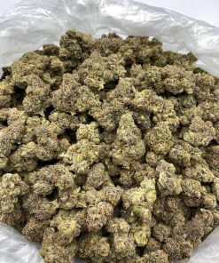 Close-up of Grape Ape cannabis flower showing deep purple leaves and sticky resin on buds