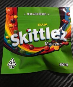 Colorful Skittles candy pouch with rainbow candies spilling out.