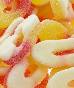 Vibrant peach ring-shaped edibles with natural fruit flavor, individually wrapped in a fun candy design.