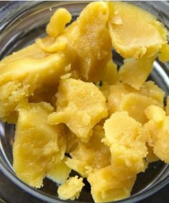 Golden-green Tahoe OG Wax concentrate in glass jar