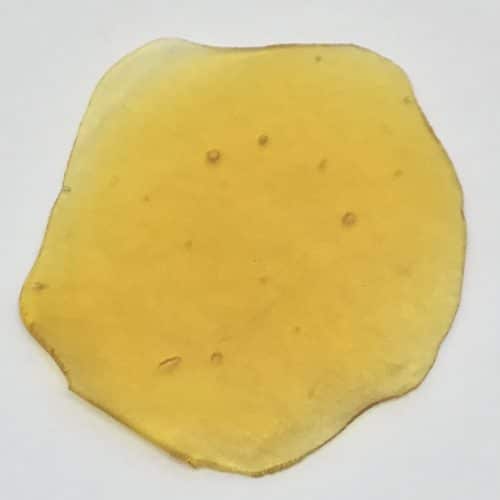 Khalifa Kush shatter concentrate amber glass-like slab with 84% THC, available in 7g, 14g, and 28g at Florida Gas Packs